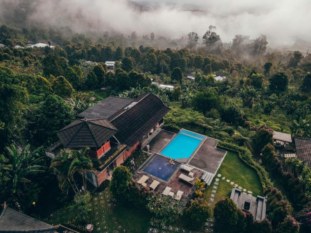 an aerial view of a house with a swimming pool at Munduk Menir Villas in Munduk