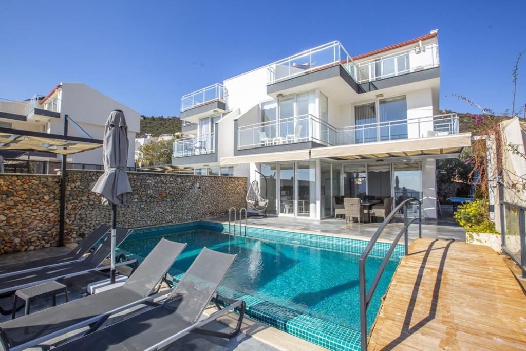 a house with a swimming pool next to a building at Villa Royal 1 in Kalkan