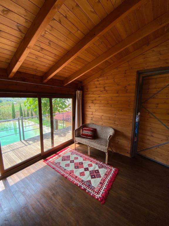 a room with a bench and a rug on a floor at Farm SuLove 