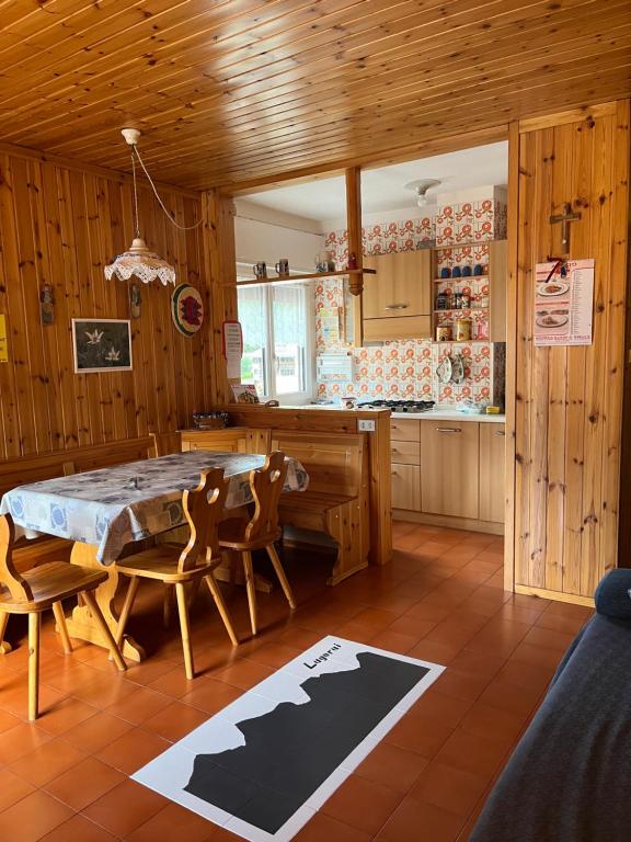 a kitchen with a table and chairs in a room at Casa Lulu' in Predazzo
