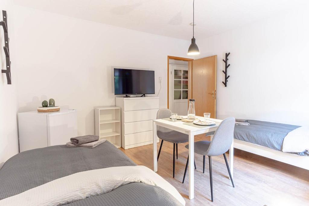 a bedroom with a bed and a table with chairs at Modern Apartment in Lüdenscheid in Lüdenscheid