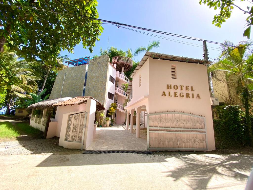 a hotel al salsa is next to a building at Hotel Alegria in Cabarete