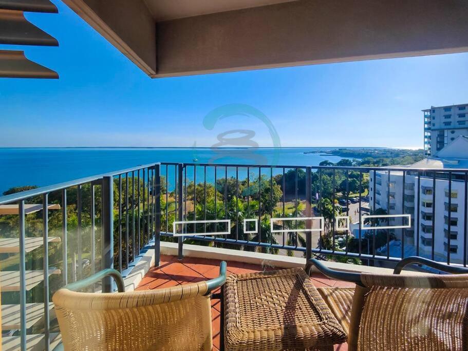 a balcony with chairs and a view of the ocean at ZEN88 ESPLANADE: 1-BR Top Floor Ocean View Suite in Darwin