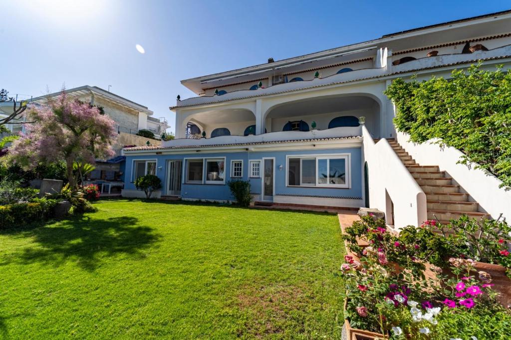 a large house with a green yard at Casa Azzurra in Messina