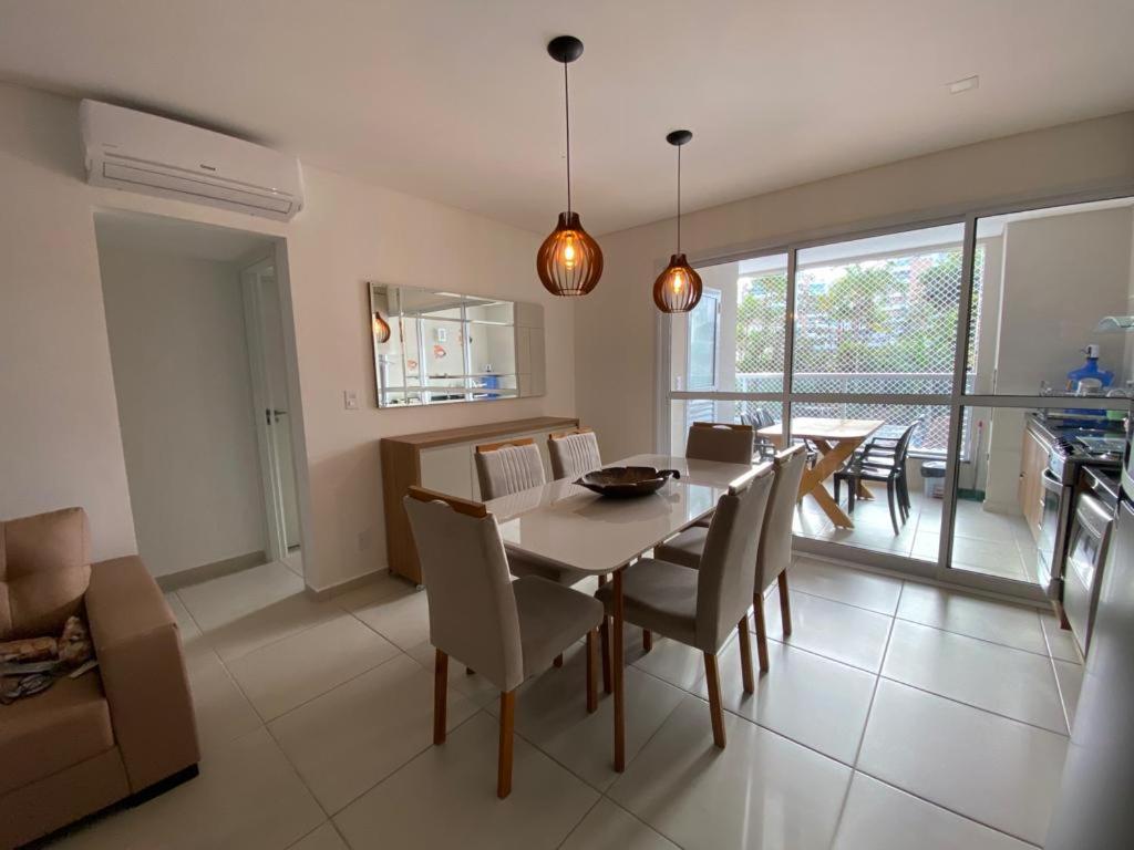 a kitchen and dining room with a table and chairs at Ubatuba in Ubatuba