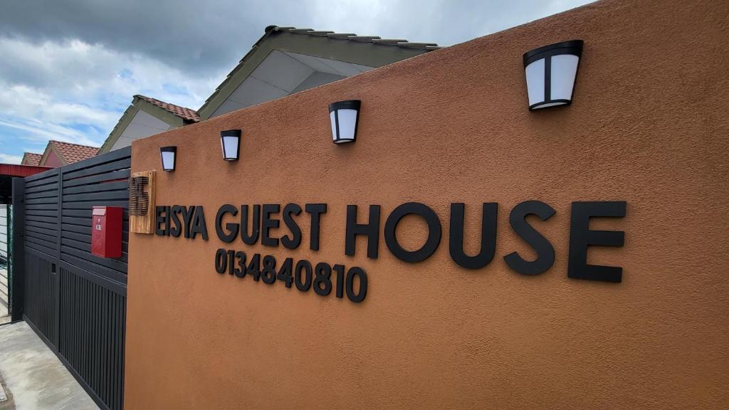 a building with the sign for a casa guest house at Eisya Guest House With Pool in Arau