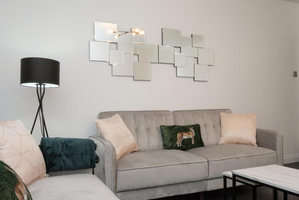 a living room with a couch and a chandelier at K Suites - Fulbridge Road in Peterborough