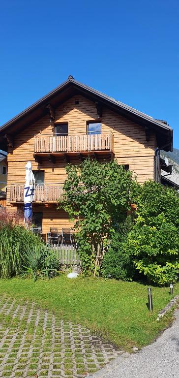 ein Holzhaus mit einem Balkon an der Seite in der Unterkunft Ferienwohnung Brader in Hallstatt