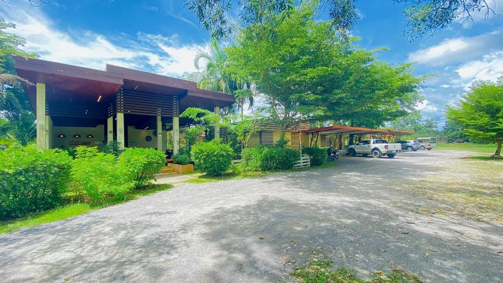 a house with a car parked in front of it at Kuapa Resort in Takua Pa