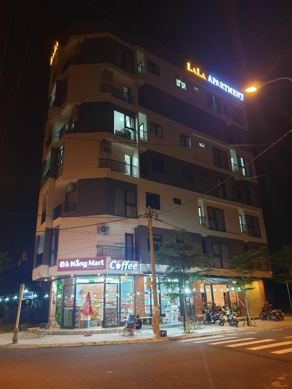 a building with a store in front of it at night at LaLa Apartment and Hotel in Danang