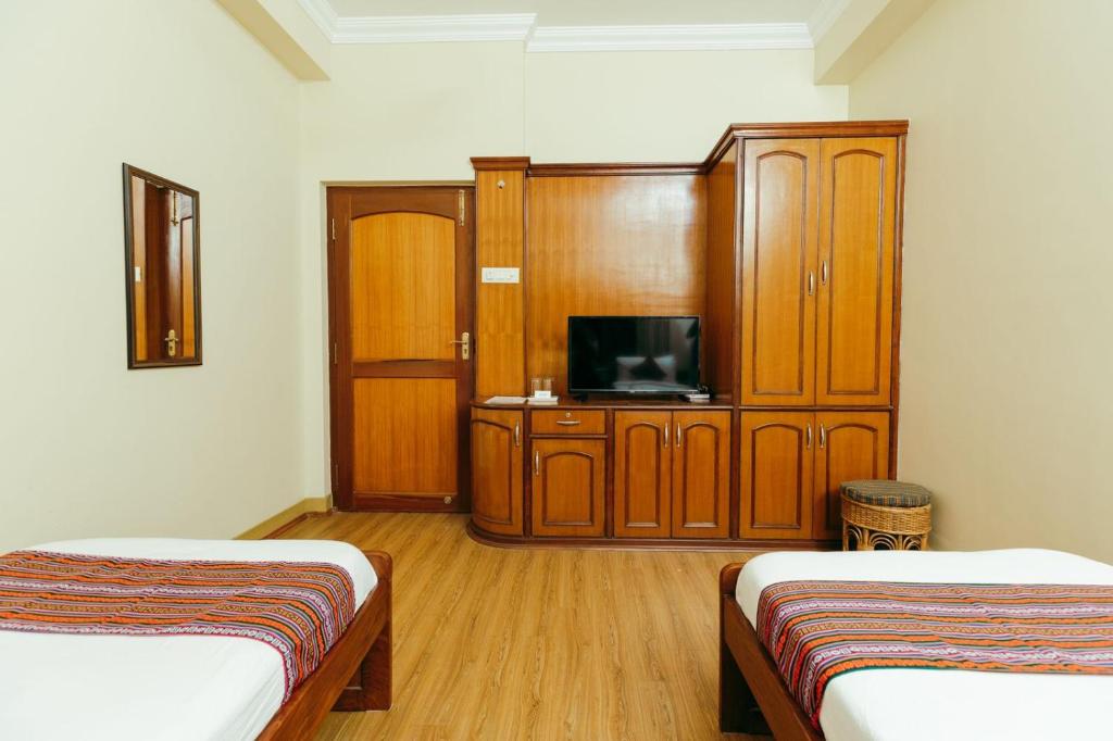 Postel nebo postele na pokoji v ubytování Tise Hotel