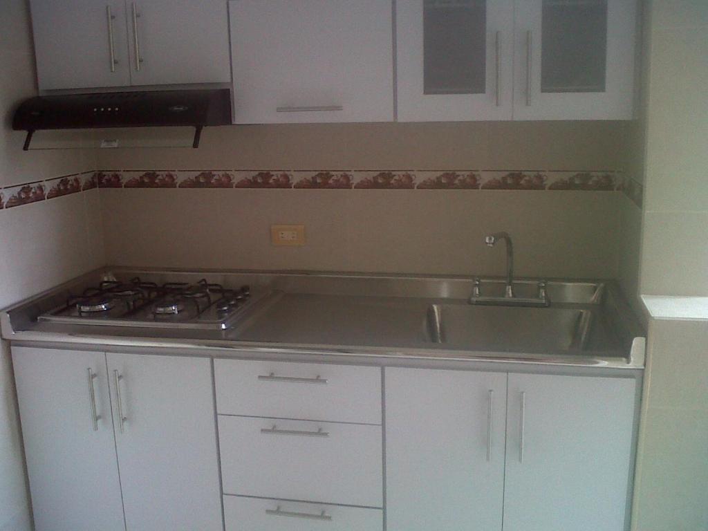 a kitchen with a sink and a stove at Mirador del parque in Bogotá