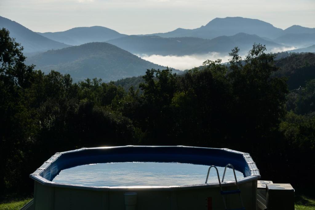 a bath tub with a view of mountains at Casa Rural El Callís in Vall de Bianya