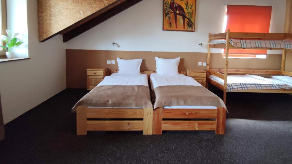 two beds in a room with two bunk beds at Mala Narnia in Frymburk