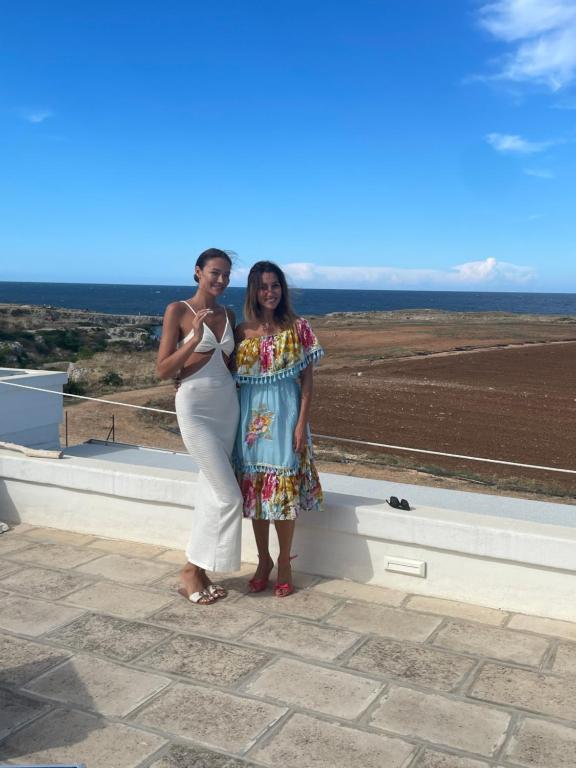 two women standing next to each other on a roof at Paradise Sea Terrace in Monopoli