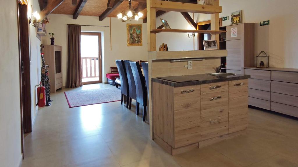 a kitchen with a sink and a wooden cabinet at Mala Narnia in Frymburk