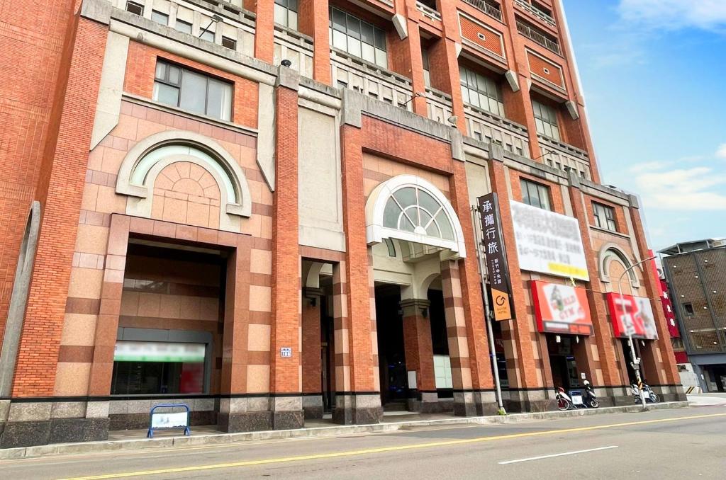 a large brick building on the side of a street at Guide Hotel Hsinchu Zhongyang in Hsinchu City