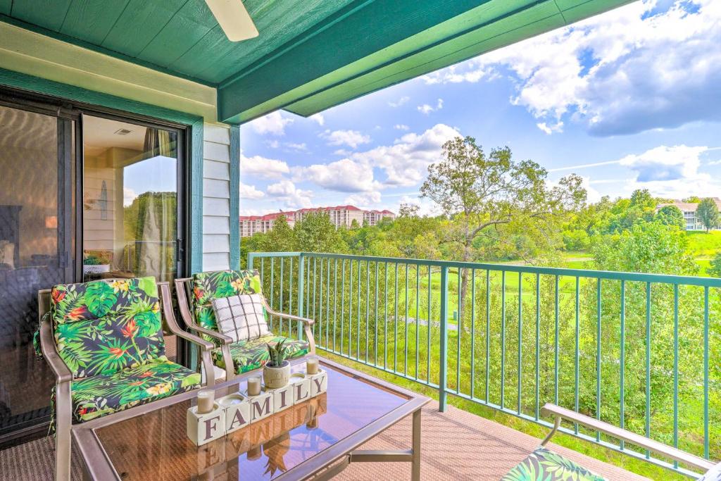 a porch with a chair and a table on a balcony at Walk to Strip! Cozy Branson Condo w/ Pool in Branson