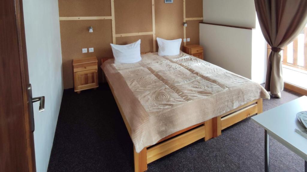 a bedroom with a large bed in a room at Mala Narnia in Frymburk