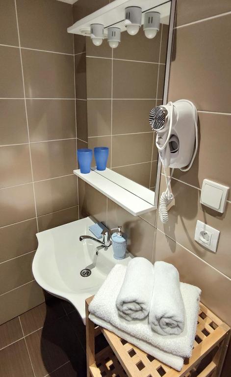 a bathroom with a sink and a mirror and towels at Mala Narnia in Frymburk