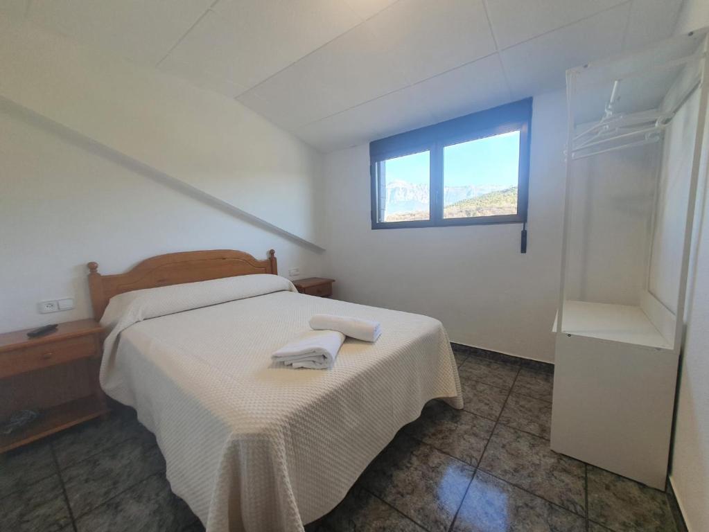 Postel nebo postele na pokoji v ubytování Hostal Apolo XI