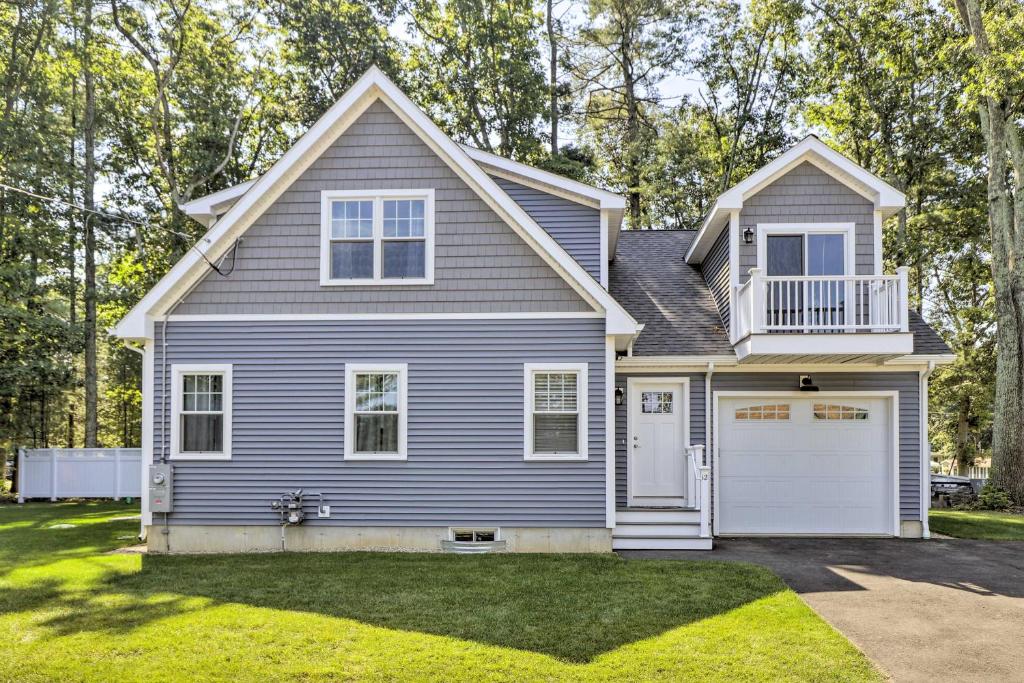 een blauw huis met een witte garage bij Sun-Dappled Retreat - Walk to Wickaboag Lake! in West Brookfield