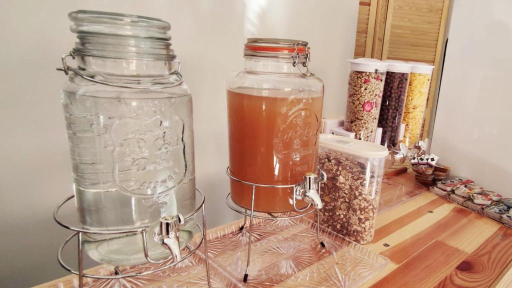 two glass jars sitting on a shelf with spices at Mala Narnia in Frymburk