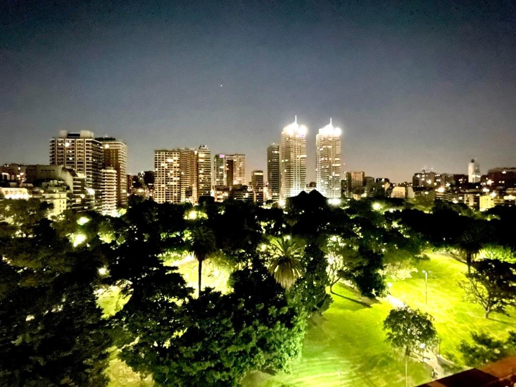 eine Skyline der Stadt bei Nacht mit Bäumen und Gebäuden in der Unterkunft PALERMO PARK VIEW APARTMENT in Buenos Aires