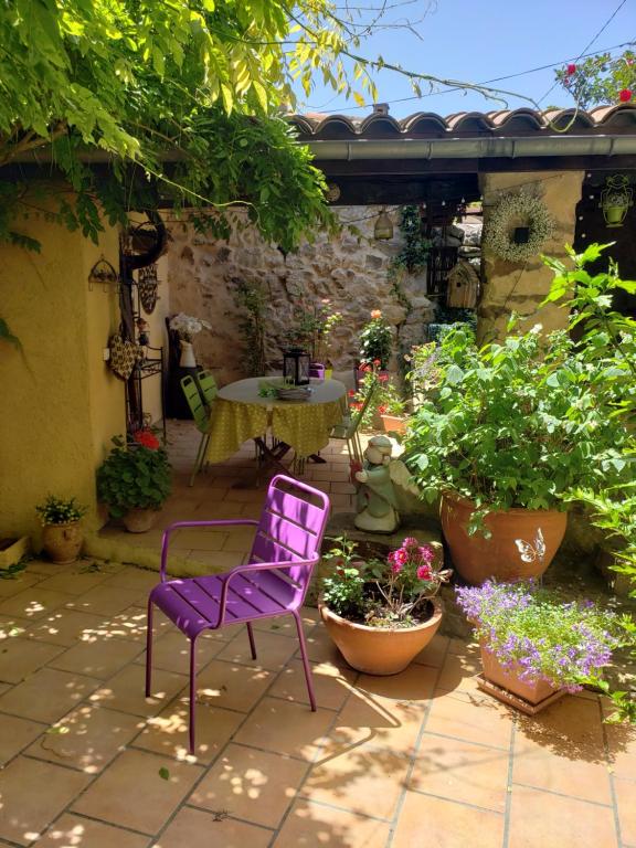 a purple chair sitting on a patio with plants at le balcon in Camps-sur-lʼAgly