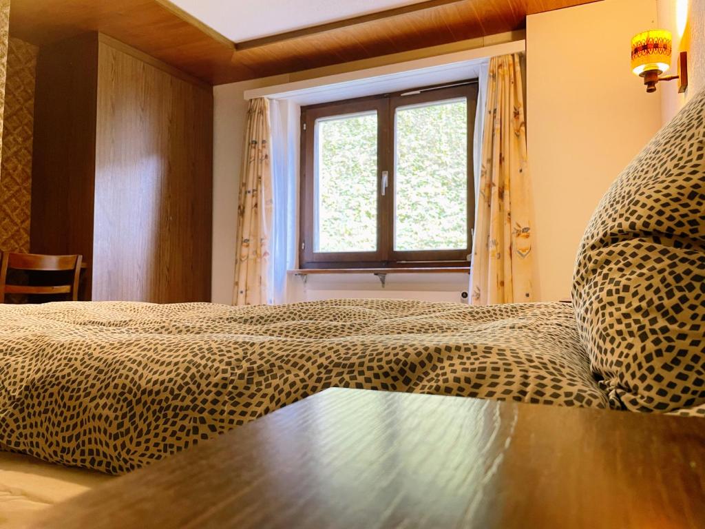 Postel nebo postele na pokoji v ubytování Hotel Gemmi