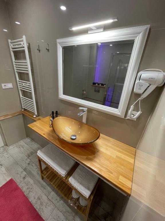 a bathroom with a sink and a large mirror at VOYAGE CUBIC Adults Only in Sibiu