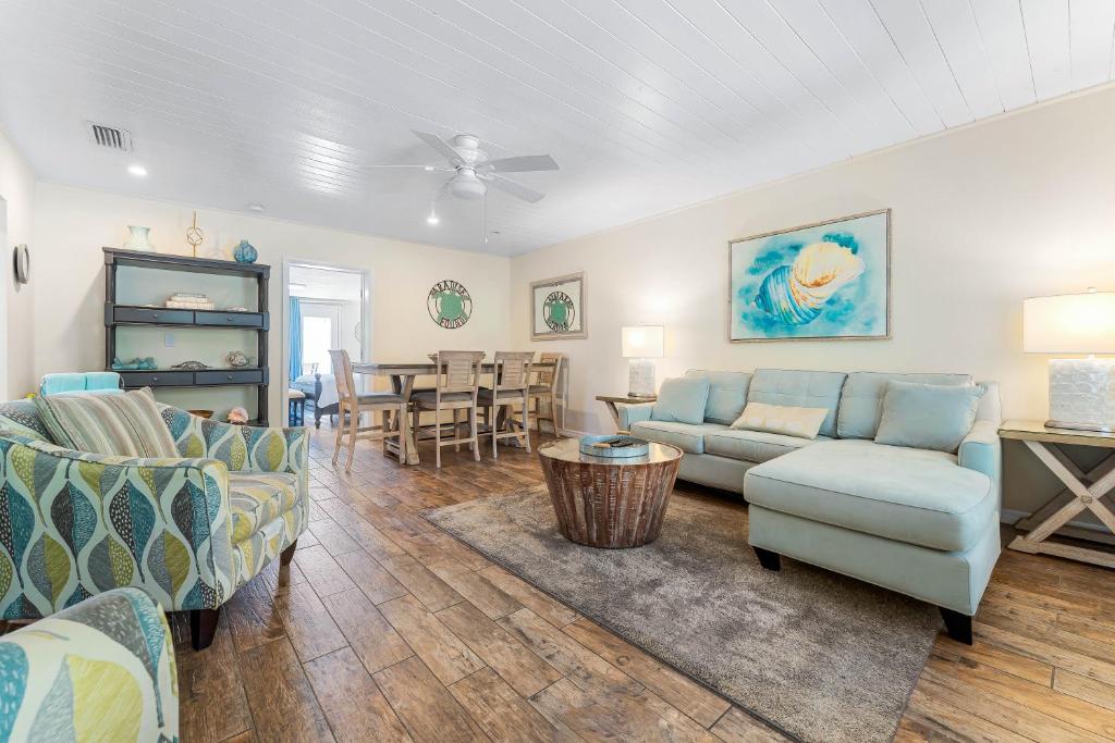 a living room with a couch and chairs and a table at Bianco Sands in Siesta Key