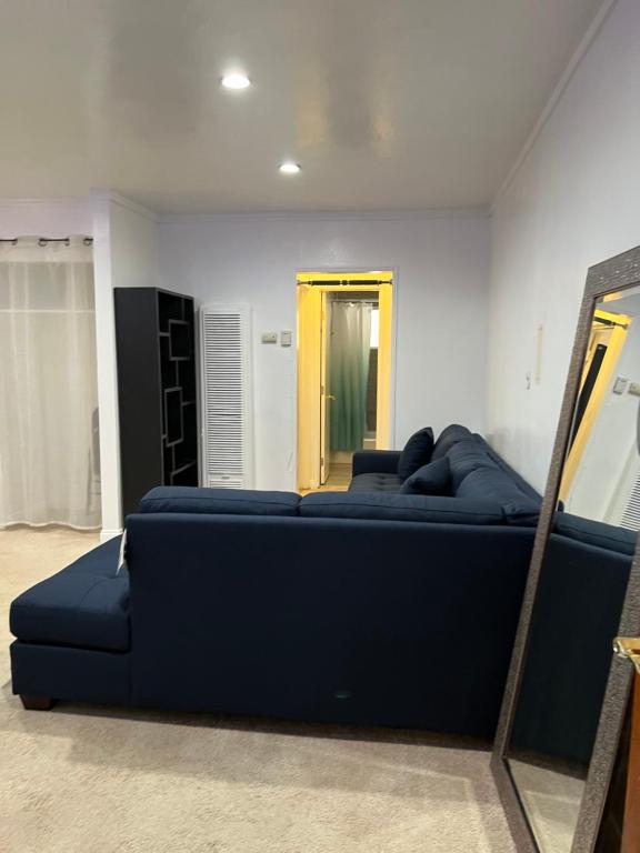 Sofá azul en una habitación con espejo en Amazing 1bd apartment with big office, en Los Ángeles