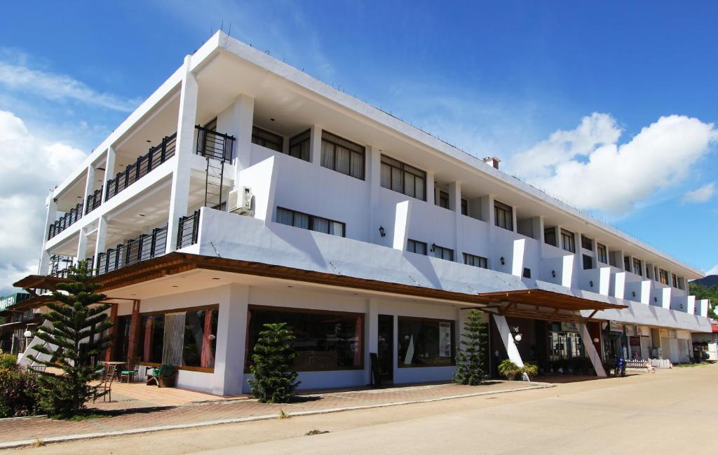 a white building with balconies on the side of it at Coron Gateway Hotel & Suites in Coron