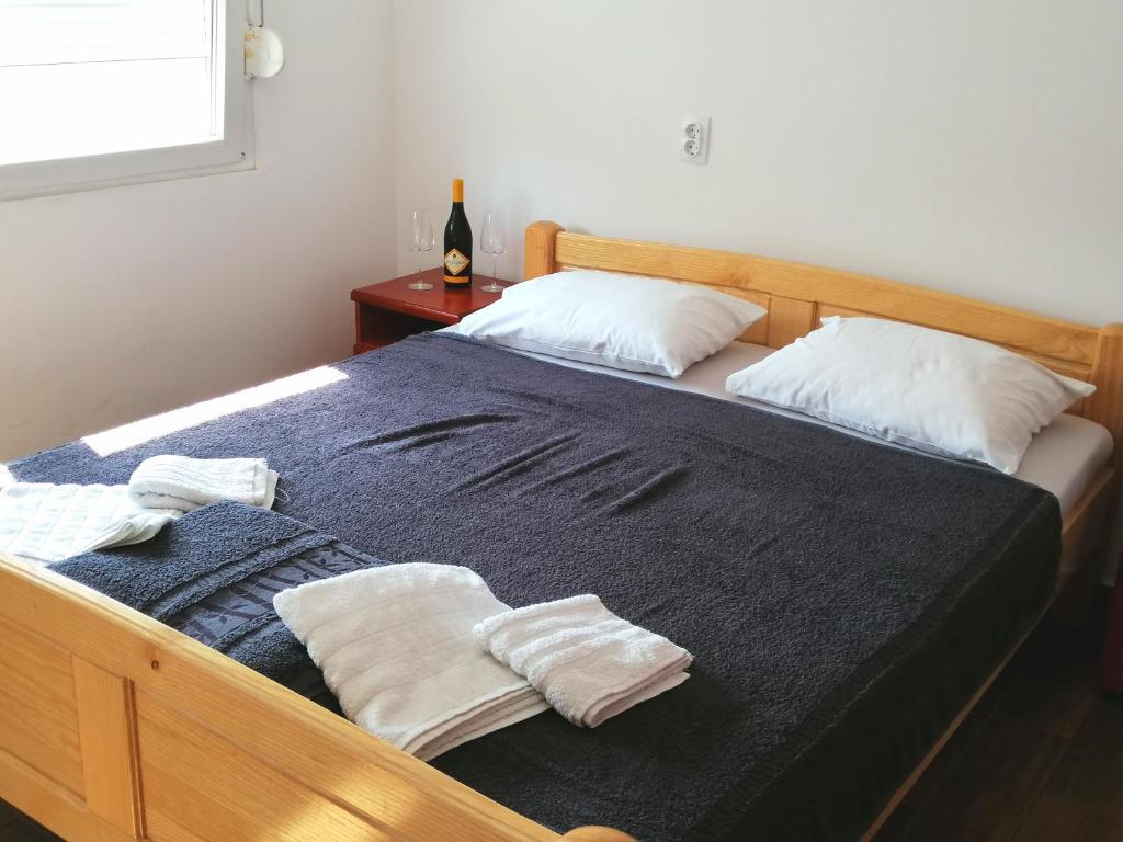 a bedroom with a bed with two towels on it at Vaš Kutak - Sobe Lux za izdavanje in Obrenovac