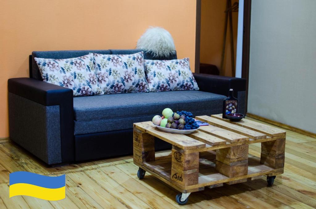 a living room with a couch and a coffee table at U&O Apartment, Liberty Square in Tbilisi City