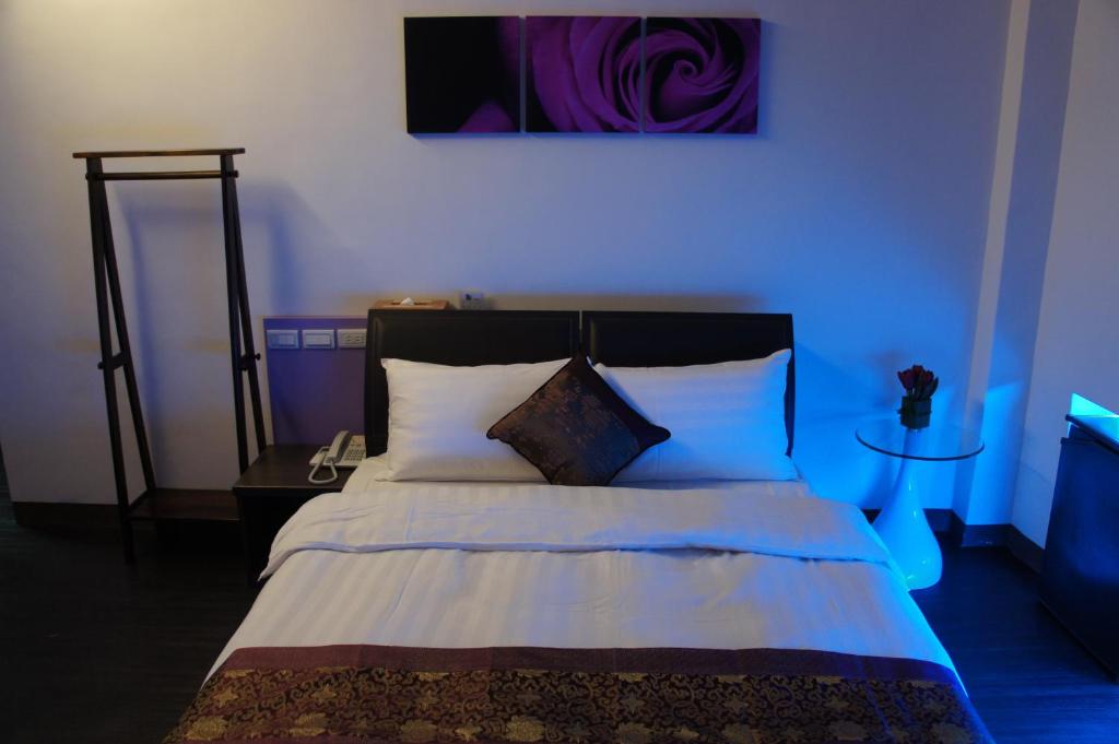 Postel nebo postele na pokoji v ubytování Yuh-Tarng Hotel