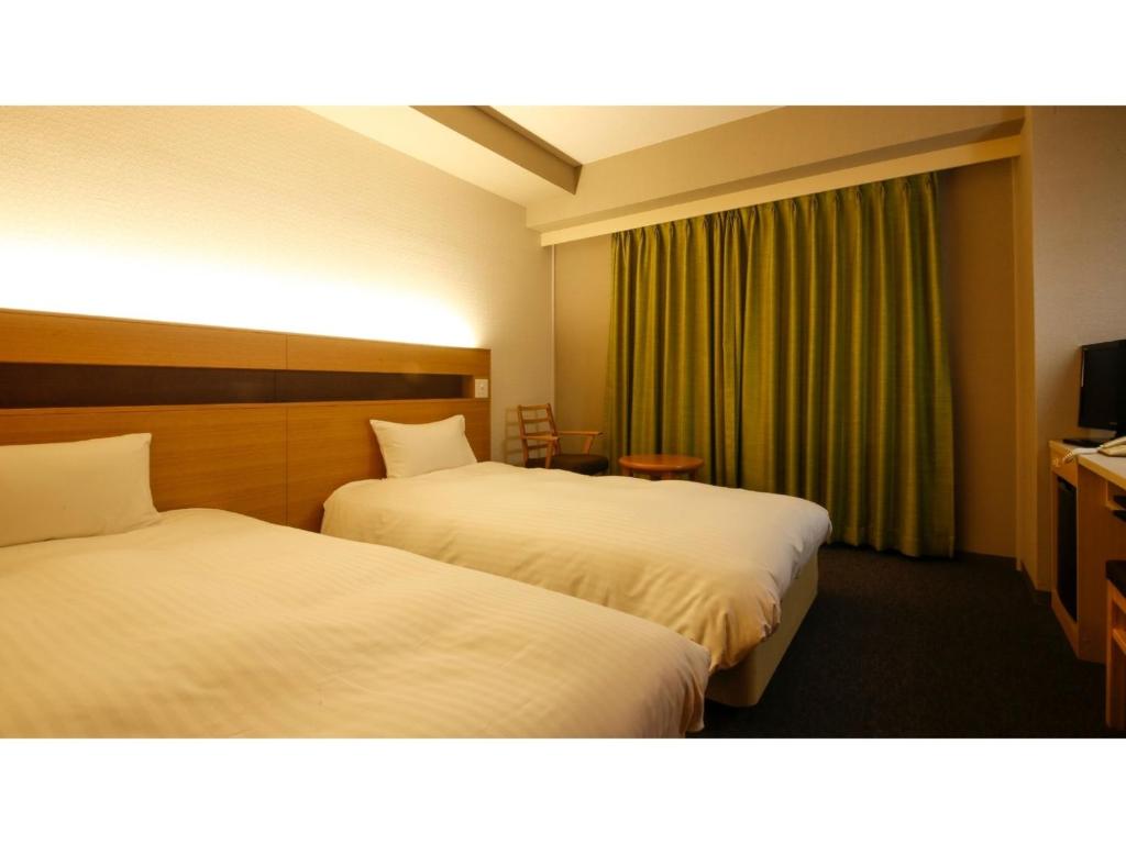 a hotel room with two beds and a television at Ako onsen AKO PARK HOTEL - Vacation STAY 21627v in Ako