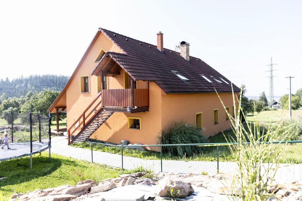 a house with a black roof on a street at Výprachtice L.V. in Výprachtice