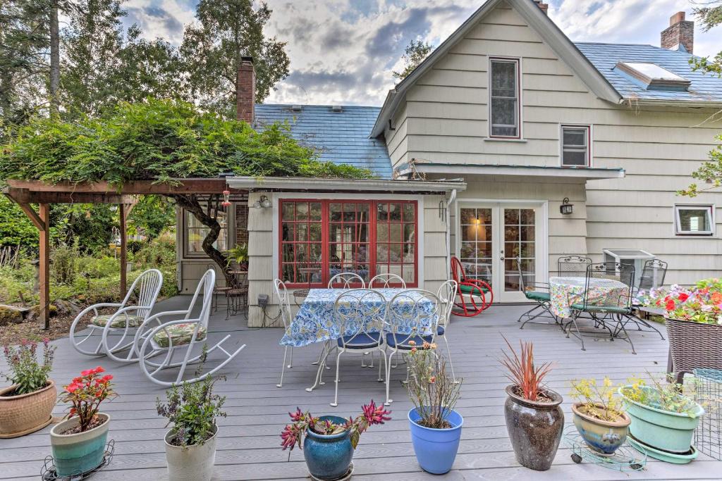 a patio with a table and chairs and potted plants at Charming Historic Retreat Near Poverty Bay! in Federal Way