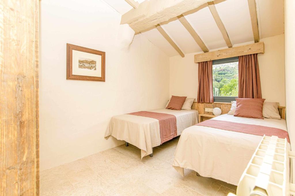 Posteľ alebo postele v izbe v ubytovaní El Molino de Besalú Casa con jardín