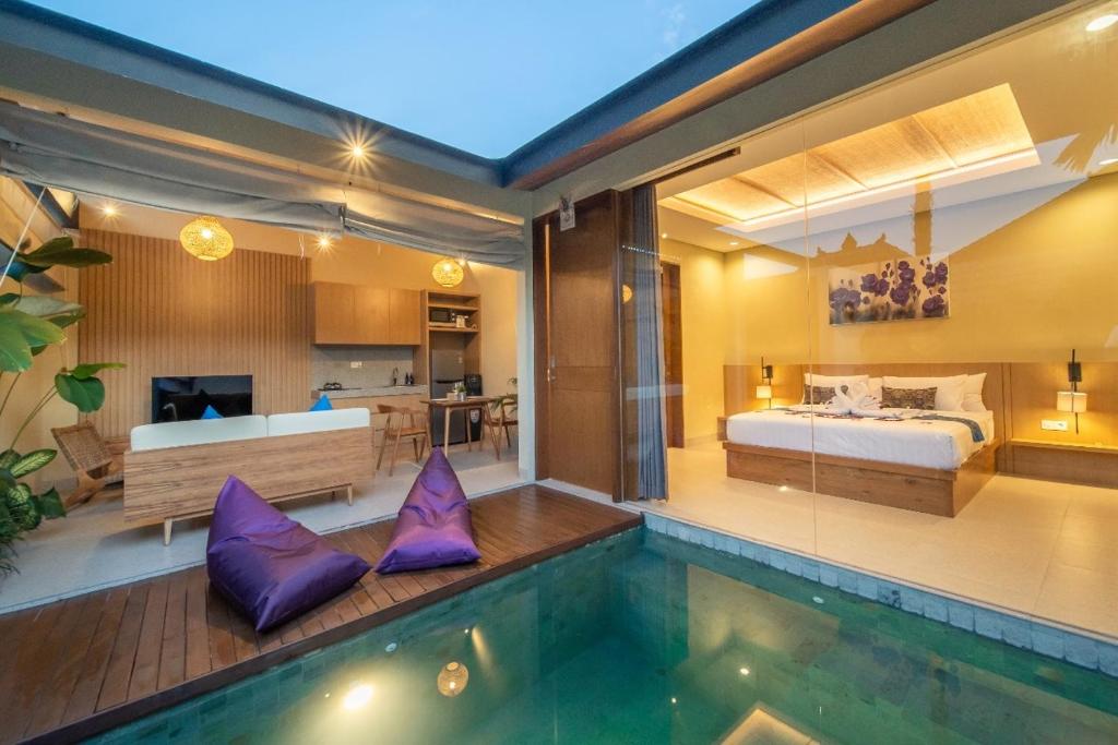a bedroom with a bed and a swimming pool at Casalita Ubud Romantic Villas in Ubud
