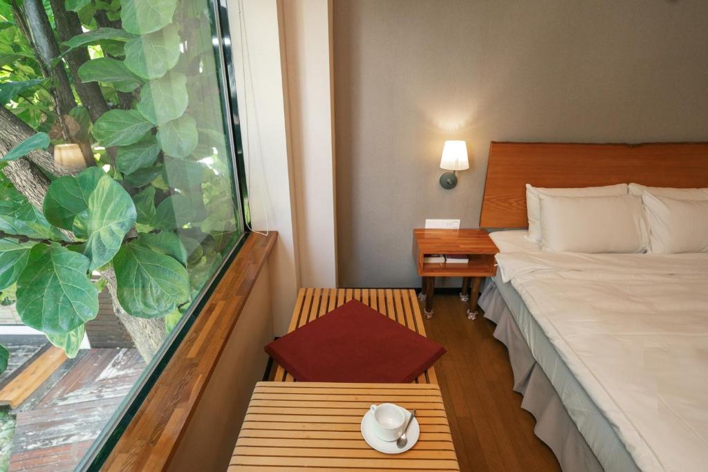 a hotel room with a bed and a window at 檜木居民宿 - 立案證號 一六三 - 一六八 - 一七零 in Ji&#39;an