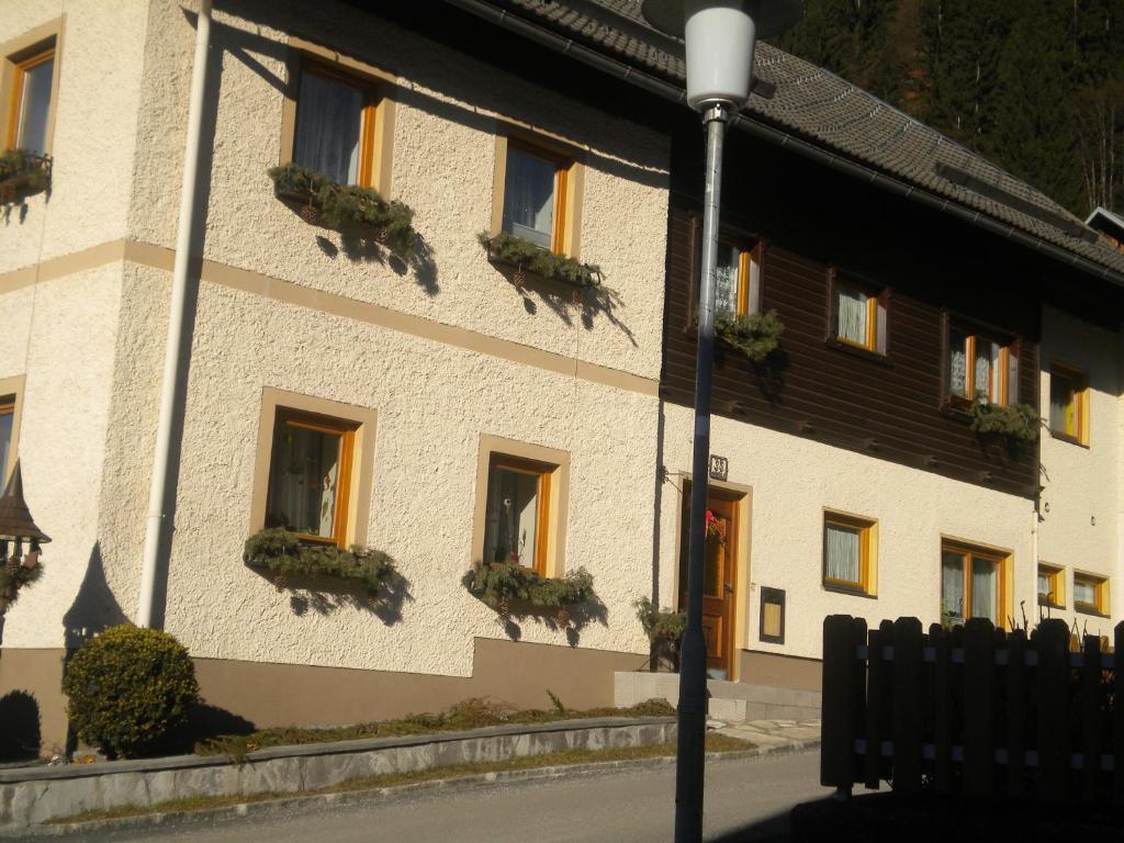 a building with potted plants on the windows of it at Haus Stöffler in Reisach