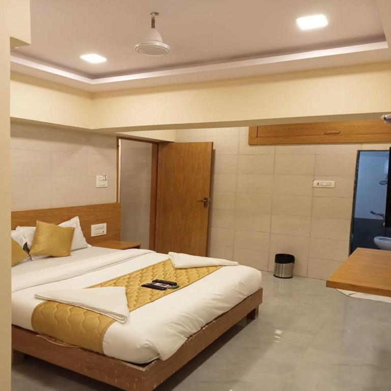 a bedroom with a large bed in a room at Hotel New Sarah Inn, Andheri West in Mumbai