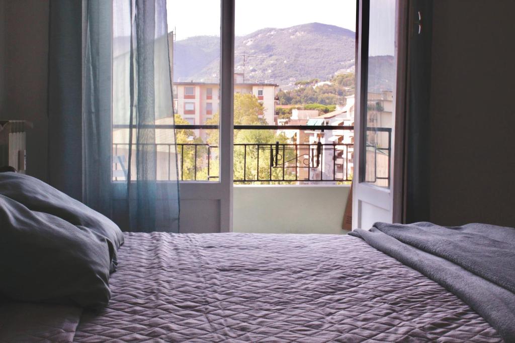 a bedroom with a bed and a large window at Foscolo 20 in La Spezia