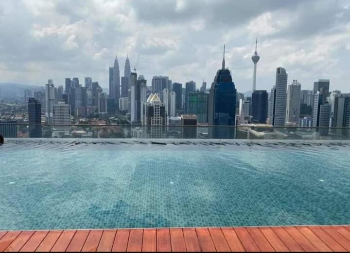 a swimming pool with a view of a city skyline at Regalia Luxury Suites and Residences @KL Homestay in Kuala Lumpur