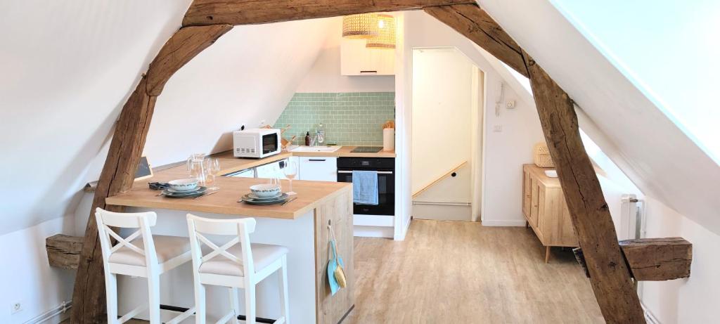 een keuken met een eiland in het midden van een kamer bij Cosy appartement, parking gratuit proche centre in Évreux