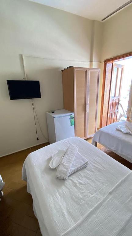 A bed or beds in a room at Saray Otel