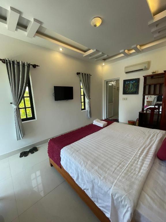 Postel nebo postele na pokoji v ubytování Red House Homestay - Villa